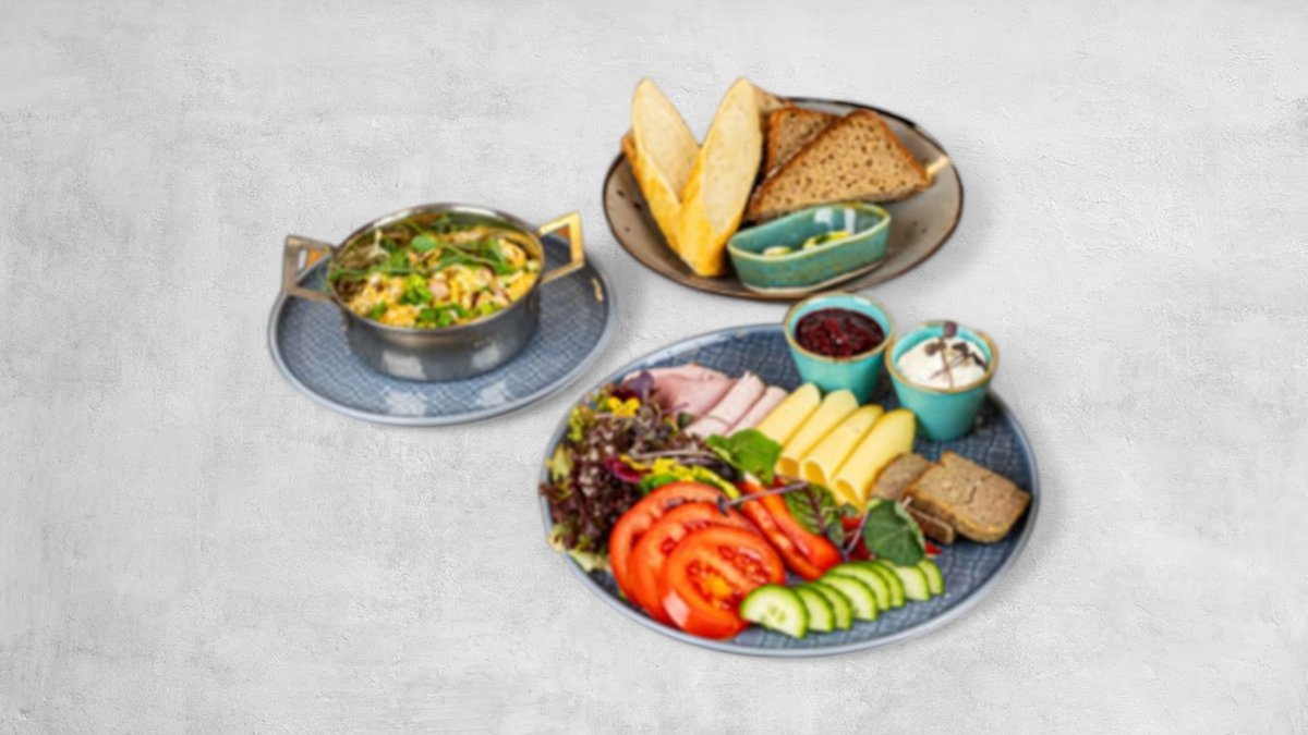 Warmia breakfast — cold cuts, cheeses, vegetables and bread on a plate