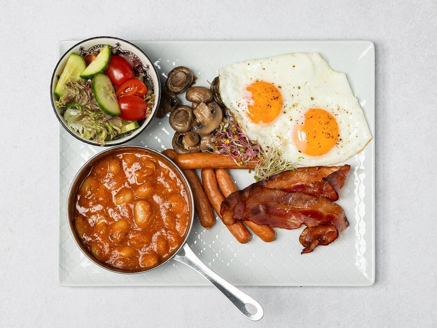 English breakfast with eggs, sausages and bread